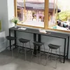 A bar table with stools placed in front of a window overlooking a street scene. Podgląd zdjęcia produktu