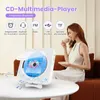A woman is drinking coffee while a CD player is displayed on a table. Produktbild-Vorschau
