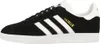 A side view of a black Adidas Gazelle sneaker with white stripes and sole. Produktbild-Vorschau