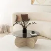 A living room scene with a couch, coffee table, and rug. Produktbild-Vorschau