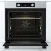 An open built-in oven with racks and baking trays inside. Produktbild-Vorschau