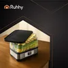 A food dehydrator filled with sliced fruits and vegetables, placed on a wooden table with a dark, abstract background. Náhled obrázku produktu