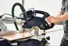 A person is using a Festool KAPEX KS 60 E-Set miter saw to cut a piece of wood. Podgląd zdjęcia produktu