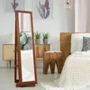 A bedroom scene with a jewelry cabinet, bed, and plants. Náhľad obrázku produktu