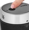 A close-up shot of the top of a black and silver stand mixer, with a finger pressing the power button. Voir les images du produit