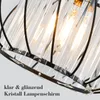 Close-up view of a crystal lampshade with a black metal frame. Produktbild-Vorschau