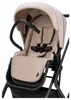 A close-up view of a beige and black stroller seat. Produktbild-Vorschau