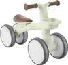 A light green balance bike with brown handlebars and seat, shown from a three-quarter front angle on a white background. Produktbild-Vorschau