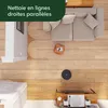 A robot vacuum cleaner is shown cleaning a wooden floor in a living room setting, with a sofa and other furniture visible. Náhled obrázku produktu