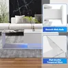 A modern white coffee table with a glass top and LED lighting in a living room setting, with close-up inserts highlighting its features. Voir les images du produit