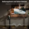 A modern desk setup with a computer monitor, lamp, and a standing desk. Produktbild-Vorschau
