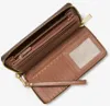 An open brown Michael Kors wallet with a wrist strap. Podgląd zdjęcia produktu