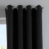 A close-up view of black curtains hanging from a curtain rod. Produktbild-Vorschau