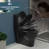 A black toilet seat is shown with its lid open, next to a sleeping person in bed, implying quiet operation. Produktbild-Vorschau