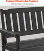 A close-up view of a black outdoor bench with a wood-like texture, set against a light-colored siding. Produktbild-Vorschau