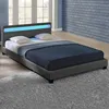 A dark gray upholstered bed with a blue LED light strip on the headboard, shown with two white pillows and a dark blue blanket. Náhled obrázku produktu