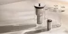 A water filter pitcher and glasses are arranged on a light-colored surface with soft shadows. Náhľad obrázku produktu