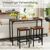A bar table and two stools are set up in a living room, next to a sofa. The table is decorated with drinks and snacks. Podgląd zdjęcia produktu