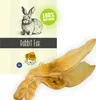 A product image showing a dried rabbit ear for pets, with packaging elements on the left. Náhled obrázku produktu