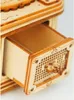 A close-up view of a wooden 3D puzzle gramophone, showing an open drawer with intricate detailing. Podgląd zdjęcia produktu