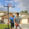 Two young men playing basketball in a suburban driveway. Produktbild-Vorschau