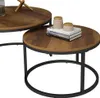 A close-up view of two nesting coffee tables with wooden tops and black metal frames. Anteprima dell’immagine prodotto