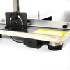 Close-up view of a cutting machine's base and adjustable guide. Náhled obrázku produktu