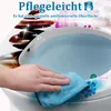 A hand is cleaning a toilet seat with a blue cloth, with decorative elements and text overlay. Produktbild-Vorschau