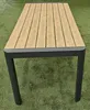 A rectangular outdoor dining table with a wood-look tabletop and dark gray metal legs, placed on artificial grass. Produktbild-Vorschau