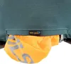 A close-up view of a teal backpack with an orange rain cover pulled out of a zippered compartment. Anteprima dell’immagine prodotto