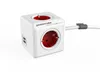A white power cube with red electrical outlets and USB ports, connected to a white cable with a grey clip. Anteprima dell’immagine prodotto