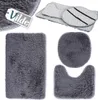 A collection of grey bath mats, including a rectangular mat, a toilet seat cover, and a U-shaped mat, arranged on a white background. A tag with the brand name 'Vilde' is visible in the top left corner. Náhled obrázku produktu