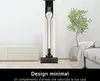 A minimalist living room scene featuring an LG CordZero vacuum cleaner in its charging stand, next to a sofa and a potted plant. Náhled obrázku produktu