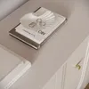 A close-up shot of a dresser top with decorative items. Produktbild-Vorschau