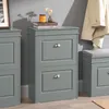 A close-up of a gray shoe cabinet with two drawers, placed next to another cabinet and against a gray wall. Produktbild-Vorschau
