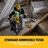 A construction worker is kneeling and organizing tools in a storage system. Produktbild-Vorschau