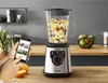 A kitchen counter with a blender, fruits, and a smartphone. Anteprima dell’immagine prodotto