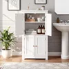 A white bathroom cabinet is shown open, displaying toiletries and towels, next to a sink and a potted plant. Produktbild-Vorschau