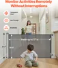 A child is playing on the floor in front of a retractable baby gate, with a woman standing behind it in a hallway. Voir les images du produit