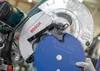 Close-up of a Bosch miter saw with a blue saw blade. Voir les images du produit