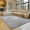 A spacious living room with a large sectional sofa and a rug. Produktbild-Vorschau