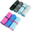 Several rolled-up microfiber towels in various colors are arranged in two rows against a white background. Anteprima dell’immagine prodotto