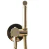 A close-up shot of a gold bidet sprayer and faucet fixture mounted on a wall. Anteprima dell’immagine prodotto