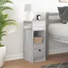 A bedside table next to a bed, with a plant and a lamp. Náhľad obrázku produktu