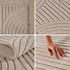 A collage of four close-up images of a textured beige rug, with one image showing a hand touching the rug. Anteprima dell’immagine prodotto