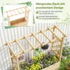 A wooden planter box with a trellis roof, adorned with hanging flower baskets and surrounded by flowers. Anteprima dell’immagine prodotto