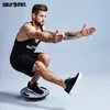 A man is performing a balance exercise on a balance board. Produktbild-Vorschau