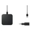 A black wireless charger pad and its accessories are displayed against a white background. Produktbild-Vorschau