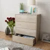 A dresser with open drawers, decorated with flowers and a lamp, in a room setting. Podgląd zdjęcia produktu