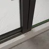 Close-up of a shower door track with a green seal. Produktbild-Vorschau